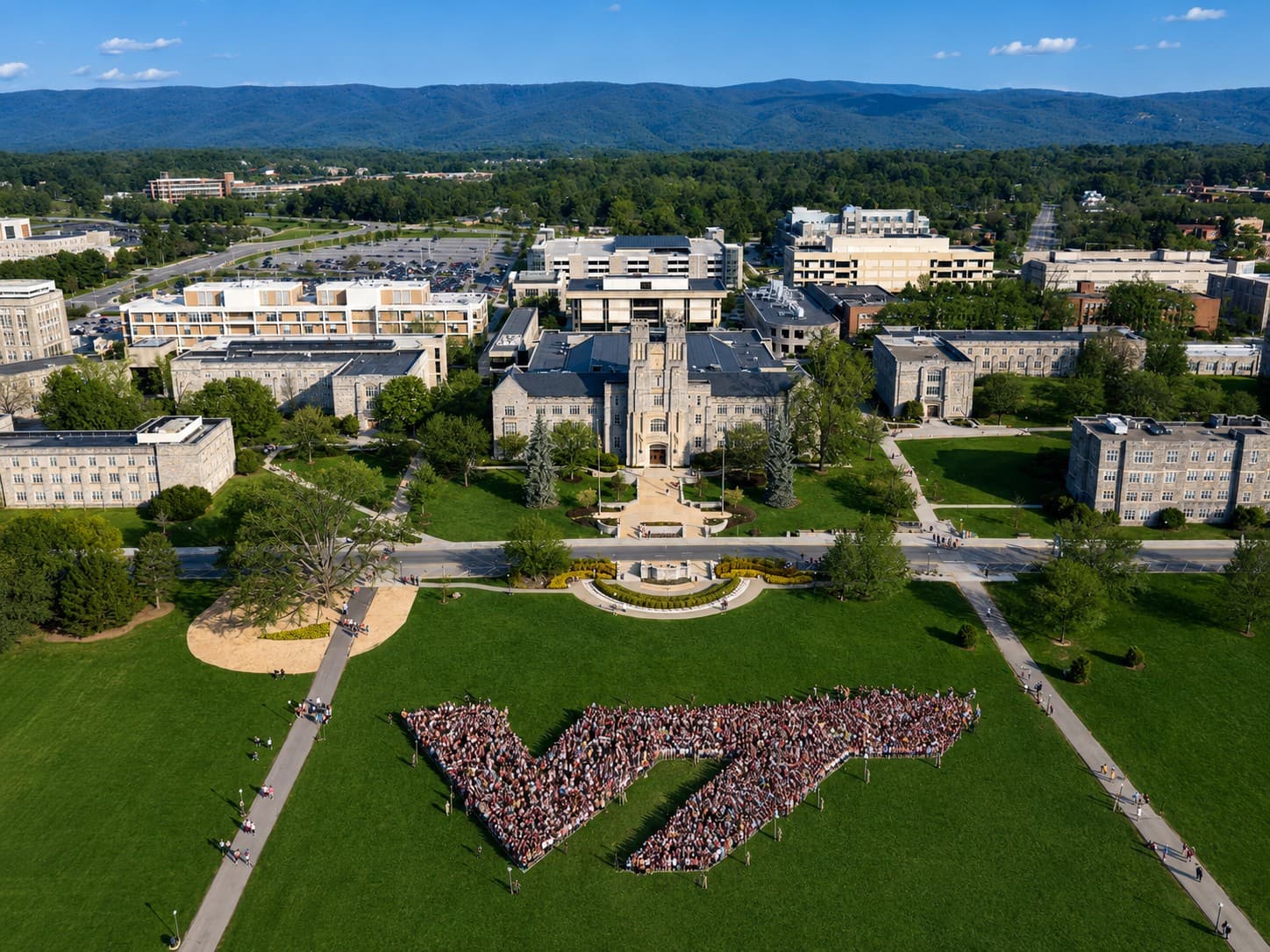 Aerial view of the Virginia Tech campus and Drillfield in Blacksburg, with the Blue Ridge Mountains beyond